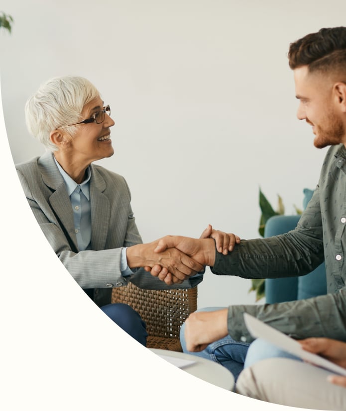 a business man and woman shake hands 